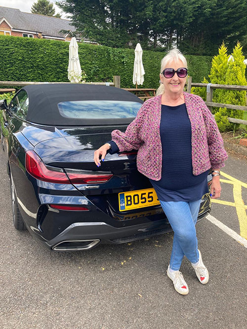 Antonia leaning on car